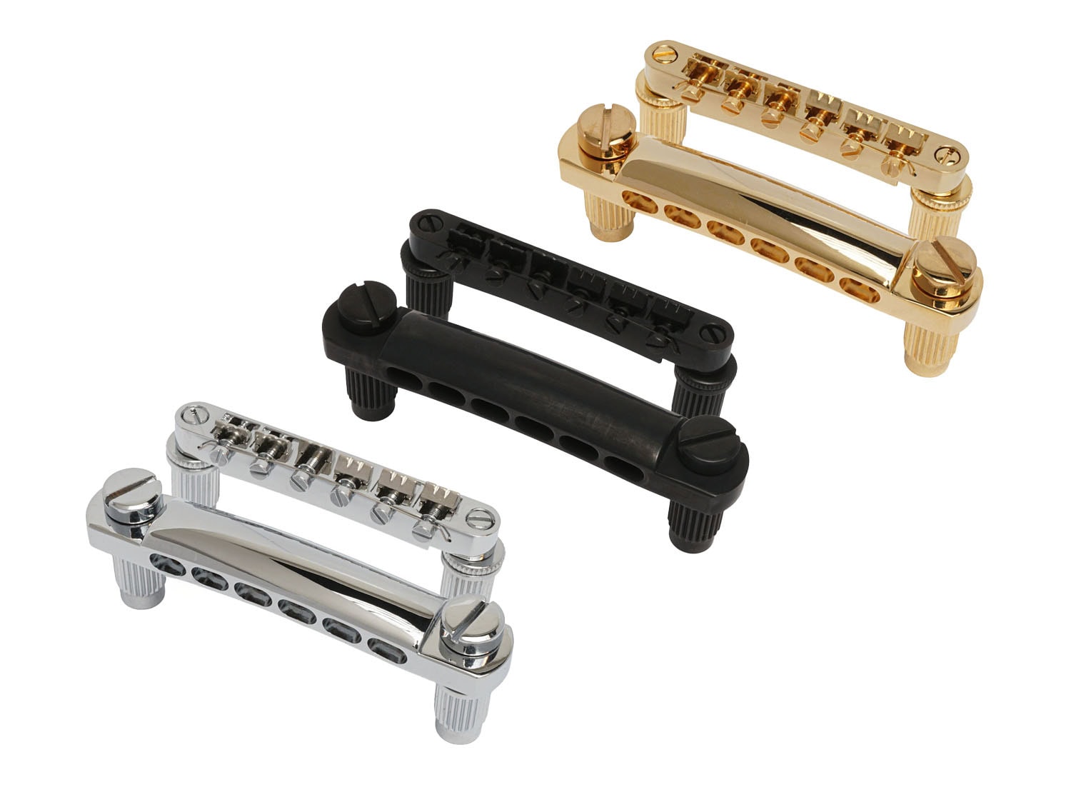 Three guitar Tune-O-Matic style bridges in gold, black, and silver finish are shown on a white background.