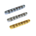 Three metallic guitar bridges in silver and gold colors with un-notched saddles shown on a white background.