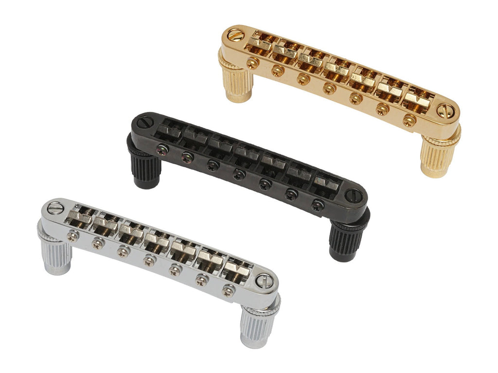 Three guitar bridges in gold, black, and silver colors shown on a white background.