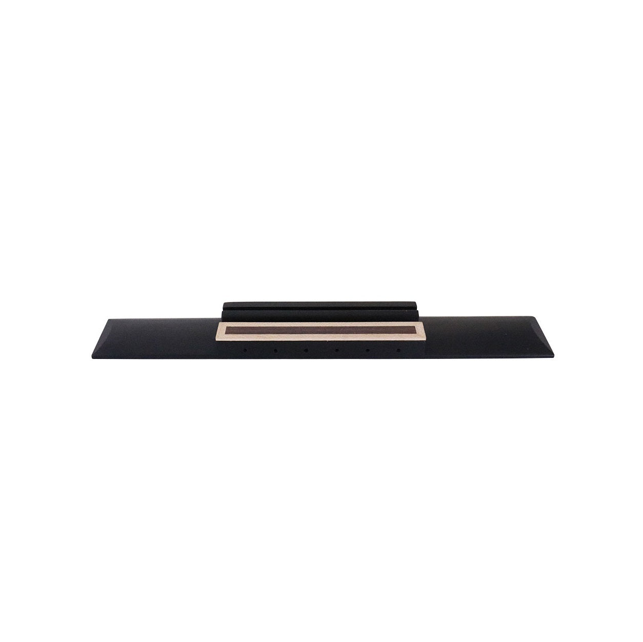 A black classical guitar bridge with a natural wood accent strip and six string holes.
