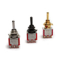 Three mini toggle switches with metal and plastic bodies, each having a different toggle lever color and six pin terminals.