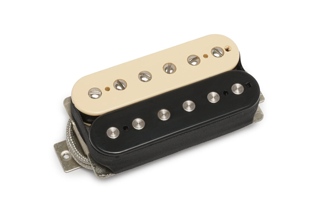 Electric guitar pickup with cream and black bobbins and exposed pole screws, shown from an angled top view.