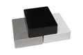 Three rectangular metal enclosures in black, white, and metallic gray stacked overlapping each other.
