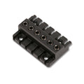 Black metal guitar bridge piece with six adjustable saddle screws shown from an angled view.