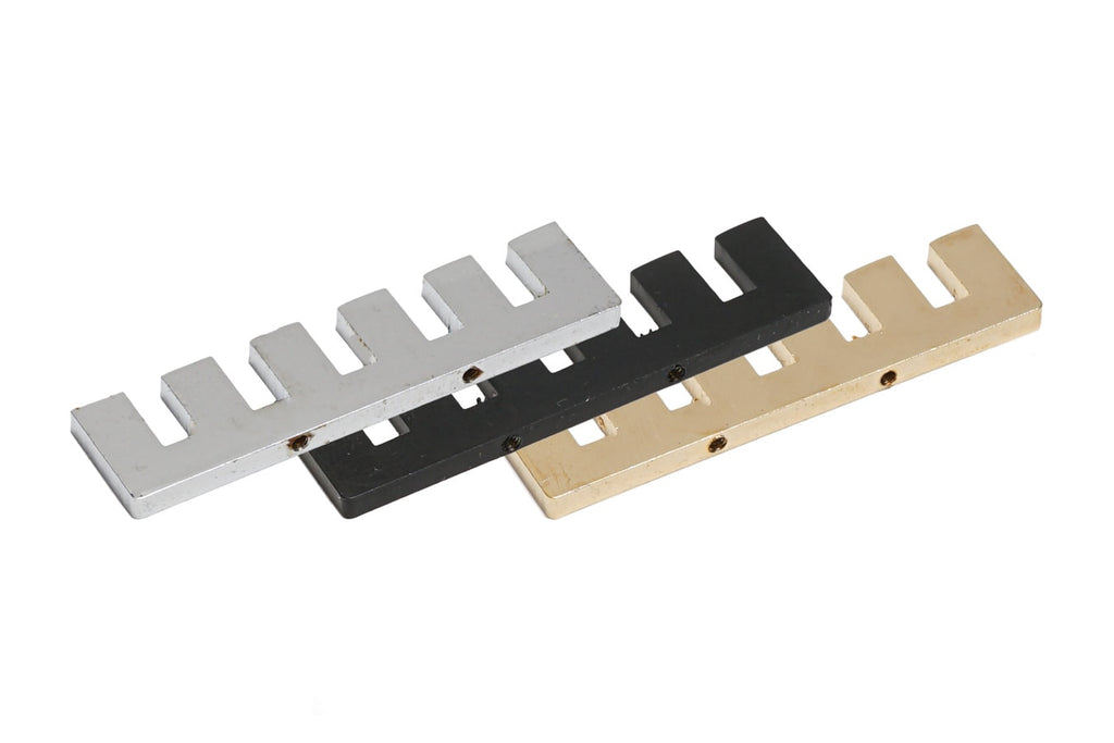 Three metal staple-shaped plates in silver, black, and gold are shown overlapping on a white background.