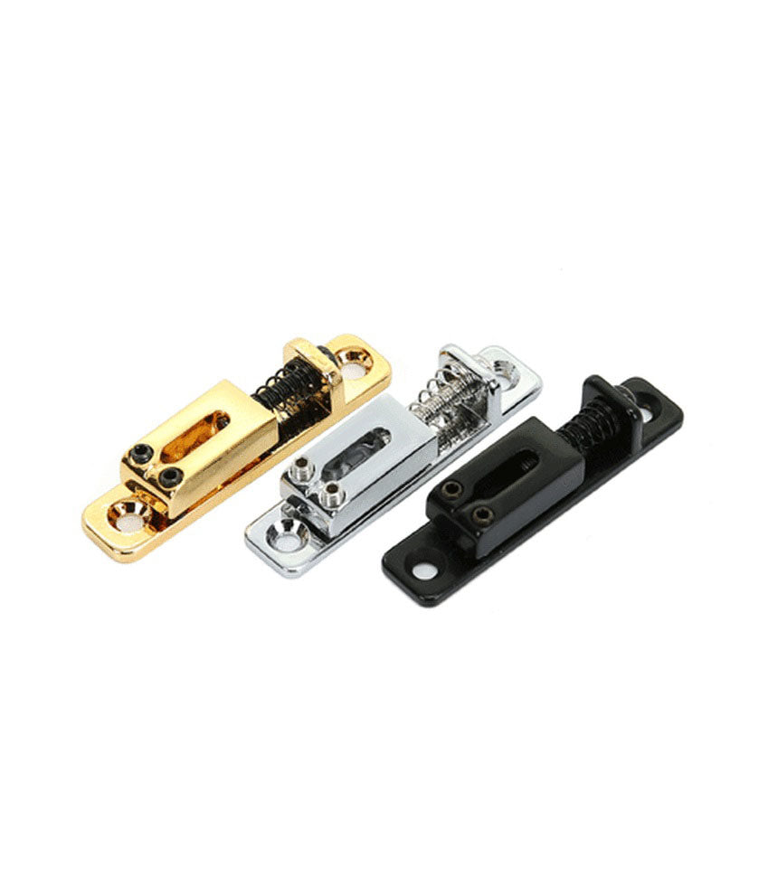 Three individual rectangular metal guitar saddles in gold, silver, and black finish with springs and adjustment screws.