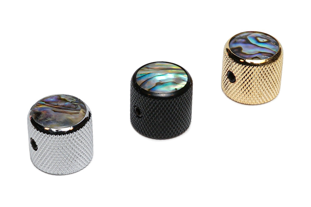Three knurled metal knobs with colorful abalone-style dome tops in silver, black, and gold finish.
