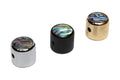 Three knurled metal knobs with colorful abalone-style dome tops in silver, black, and gold finish.