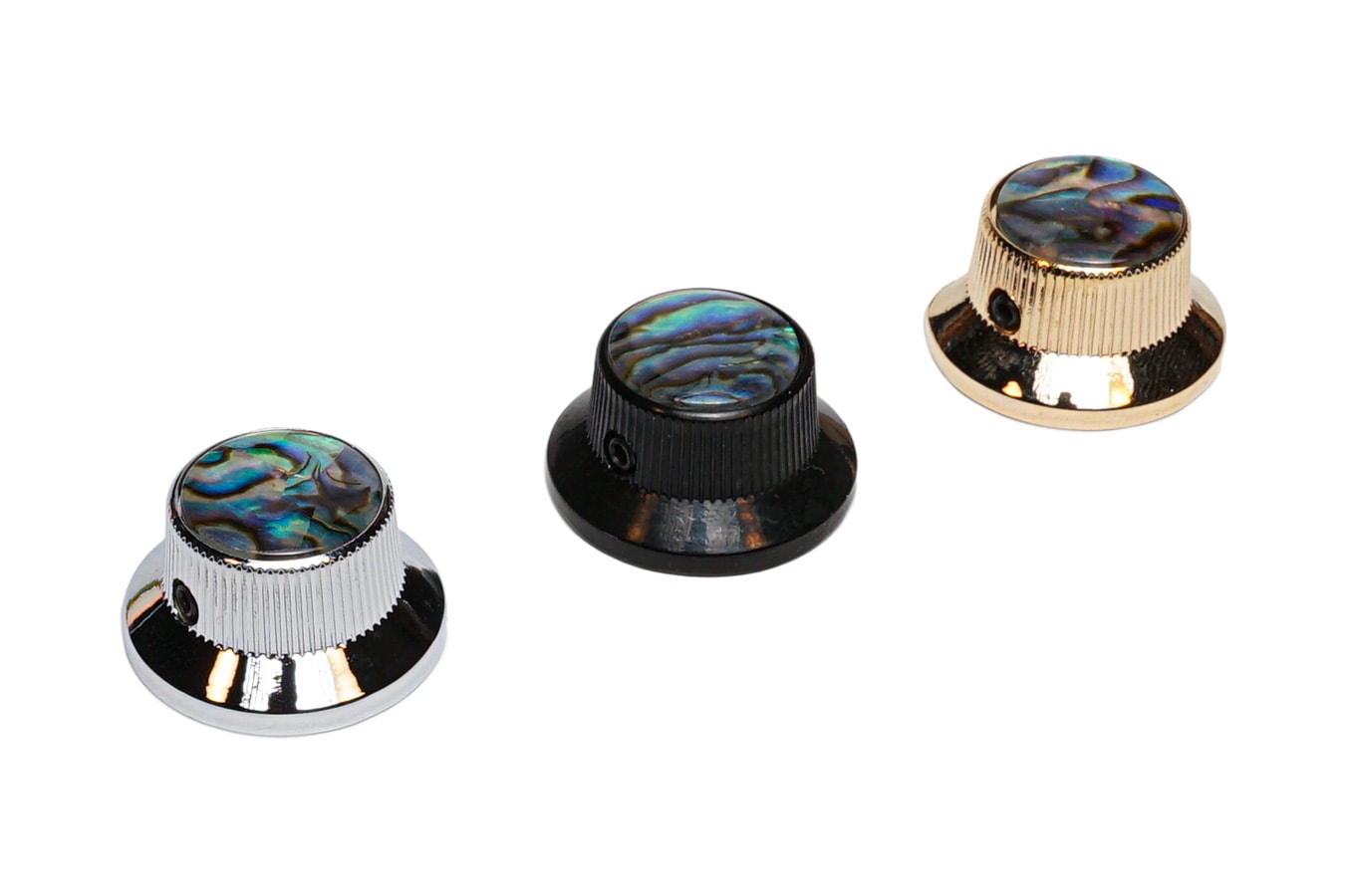 Three knurled knobs with abalone dome tops in silver, black, and gold finishes.