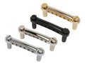 Four metal guitar tailpieces with adjustment screws in gold, black, silver, and chrome finishes.