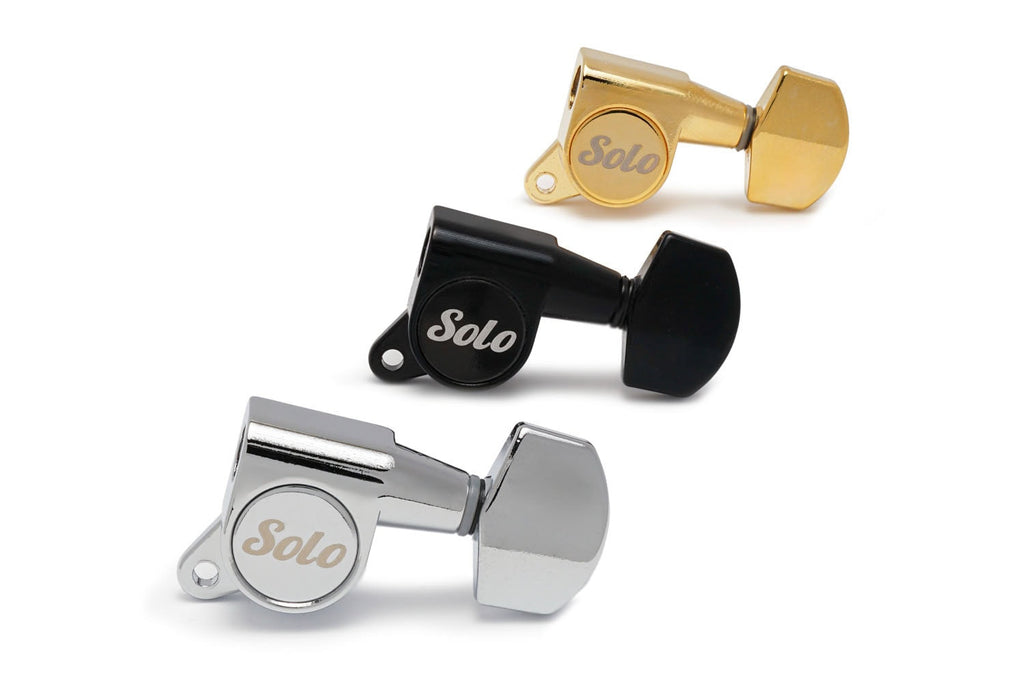 Three solo branded guitar tuning machine heads in gold, black, and silver colors on a white background.