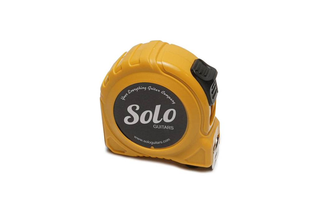 Yellow tape measure with black label and a slider lock button on the side.