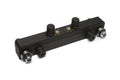 Black rectangular device with four knurled knobs, metal washers, and two brass threaded inserts on top