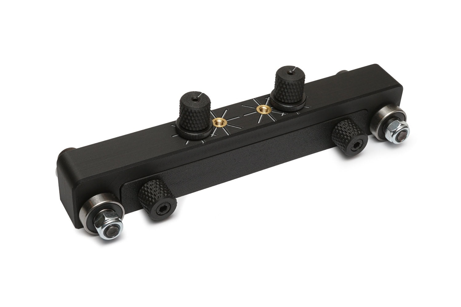 Black rectangular device with four knurled knobs, metal washers, and two brass threaded inserts on top