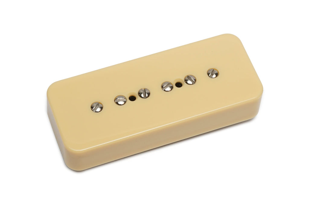 Cream-colored rectangular guitar pickup with six metal pole screws in a row on top.