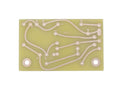 Rectangular yellow circuit board with copper traces labeled with letters and symbols including b, c, e, +, and -