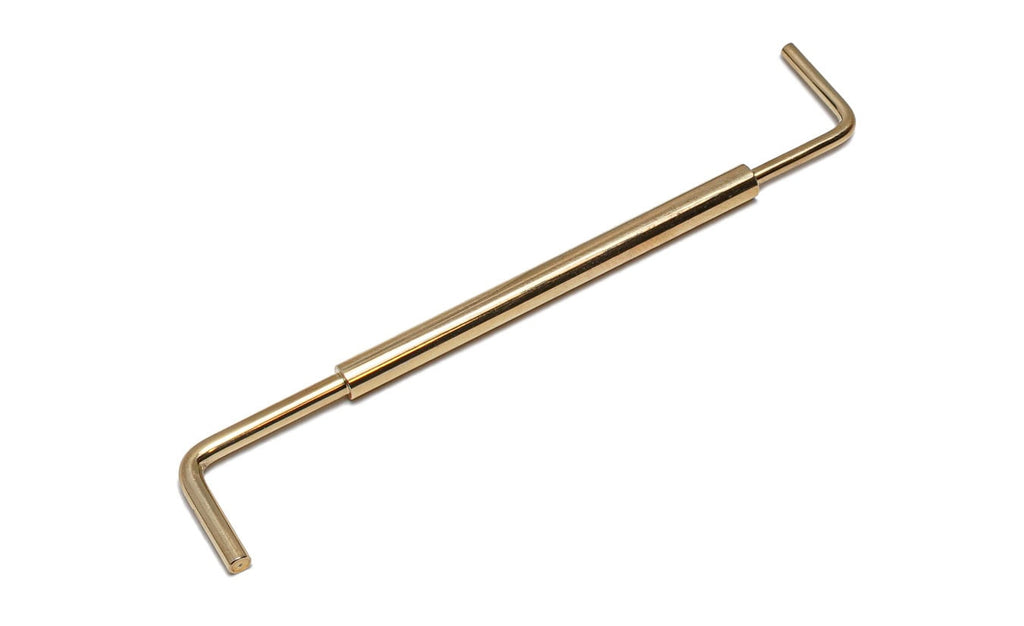A gold metal measurement gauge tool with two L-shaped ends and a cylindrical center piece.