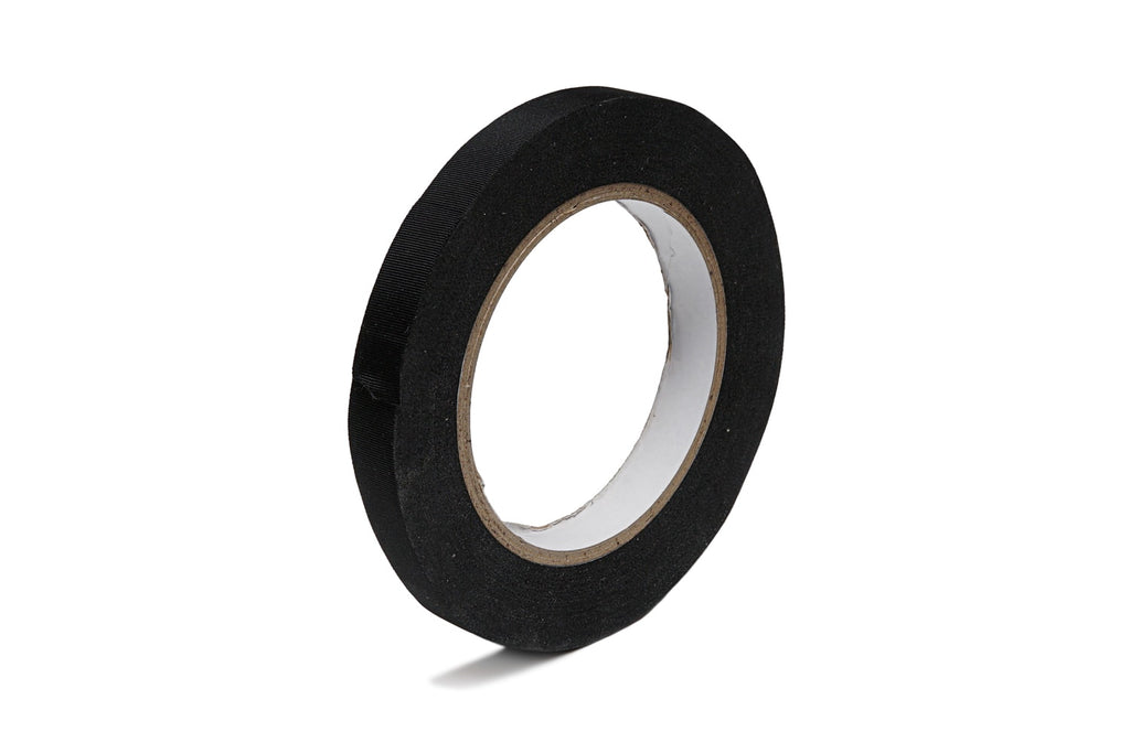 A roll of black tape with a brown cardboard core on a white background.