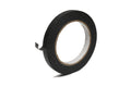 Roll of black paper tape with a small piece unrolled on a white background.