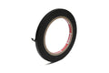 A roll of black paper adhesive tape with a partially pulled loose end, isolated on white background.