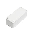Small rectangular white metal enclosure box with four screw holes on top surface.