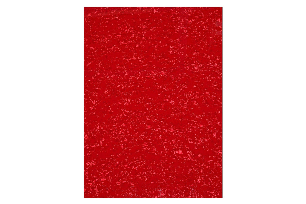 Close-up view of a textured red surface with a pearl-like pattern.