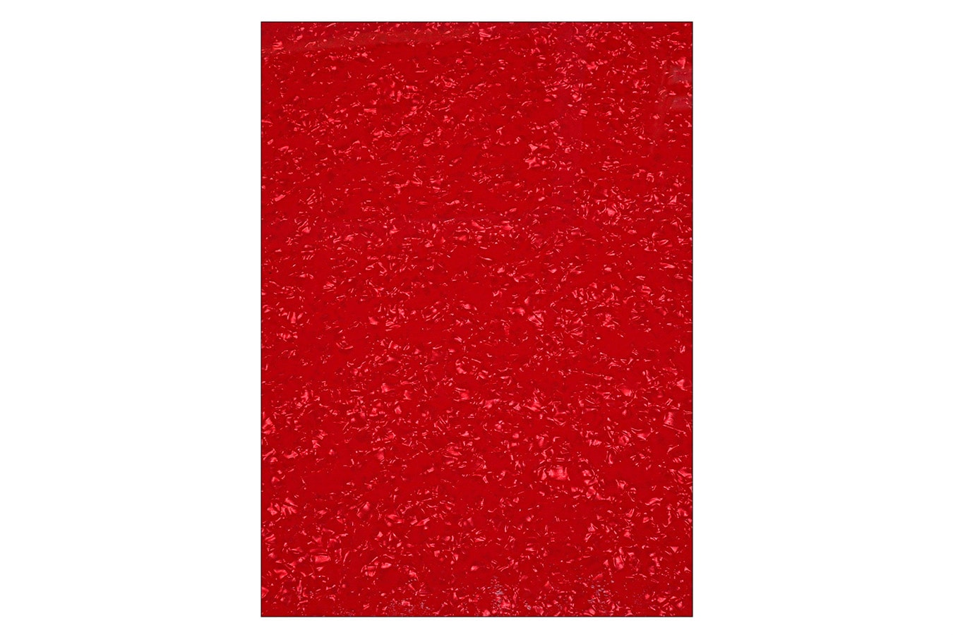 Close-up view of a textured red surface with a pearl-like pattern.