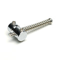 Silver metal barrel style bass saddle with attached spring and three hex screws on a white background.