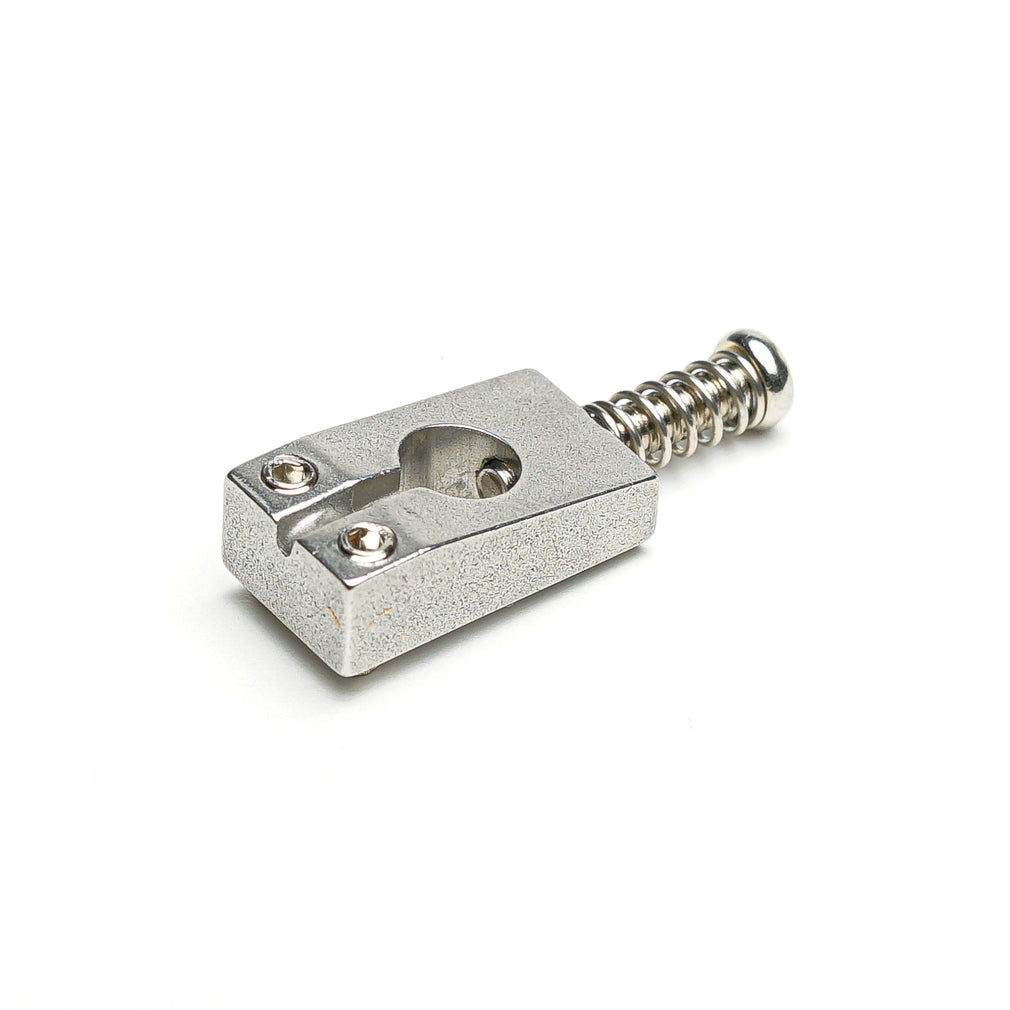Silver metal guitar saddle with two screws and a spring screw on a white background.