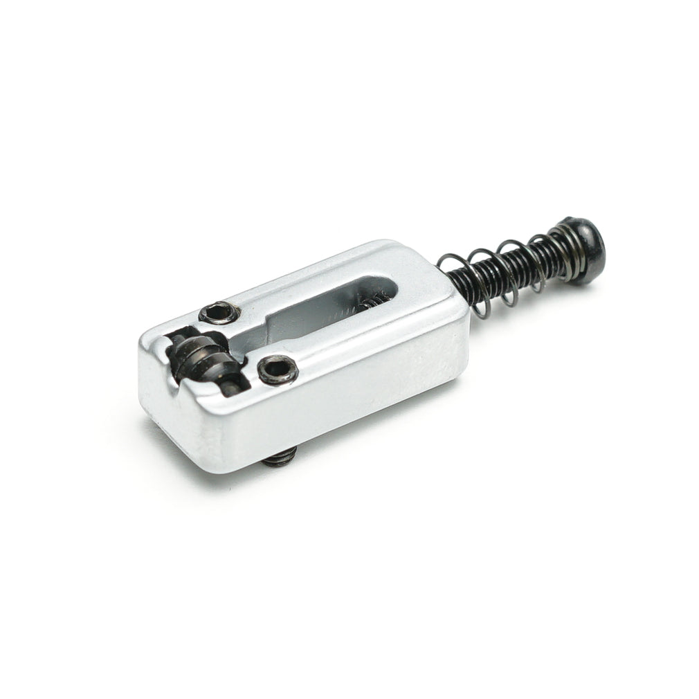 Silver metal guitar saddle with two adjustment screws and a black spring-loaded screw.