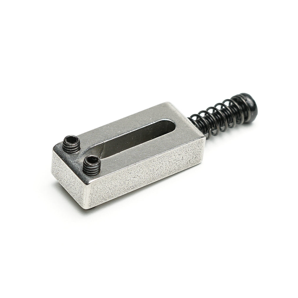 Silver-colored metal block style saddle with two black screws and a black spring attached.