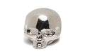 Polished silver metal skull-shaped knob viewed from the front on a white background.