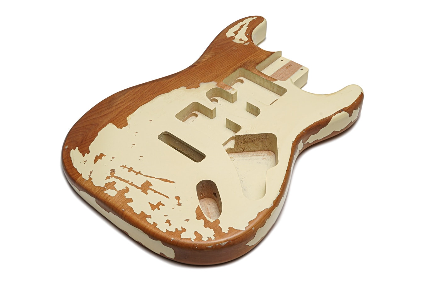 Ivory relic style electric guitar body with HSH pickup cavities and exposed natural wood areas on white background.