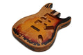 Guitar body with relic finish in 3-tone sunburst with HSH pickup cavities.