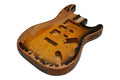 A relic finished guitar body with a 2 tone sunburst pattern and routed pickup cavities.
