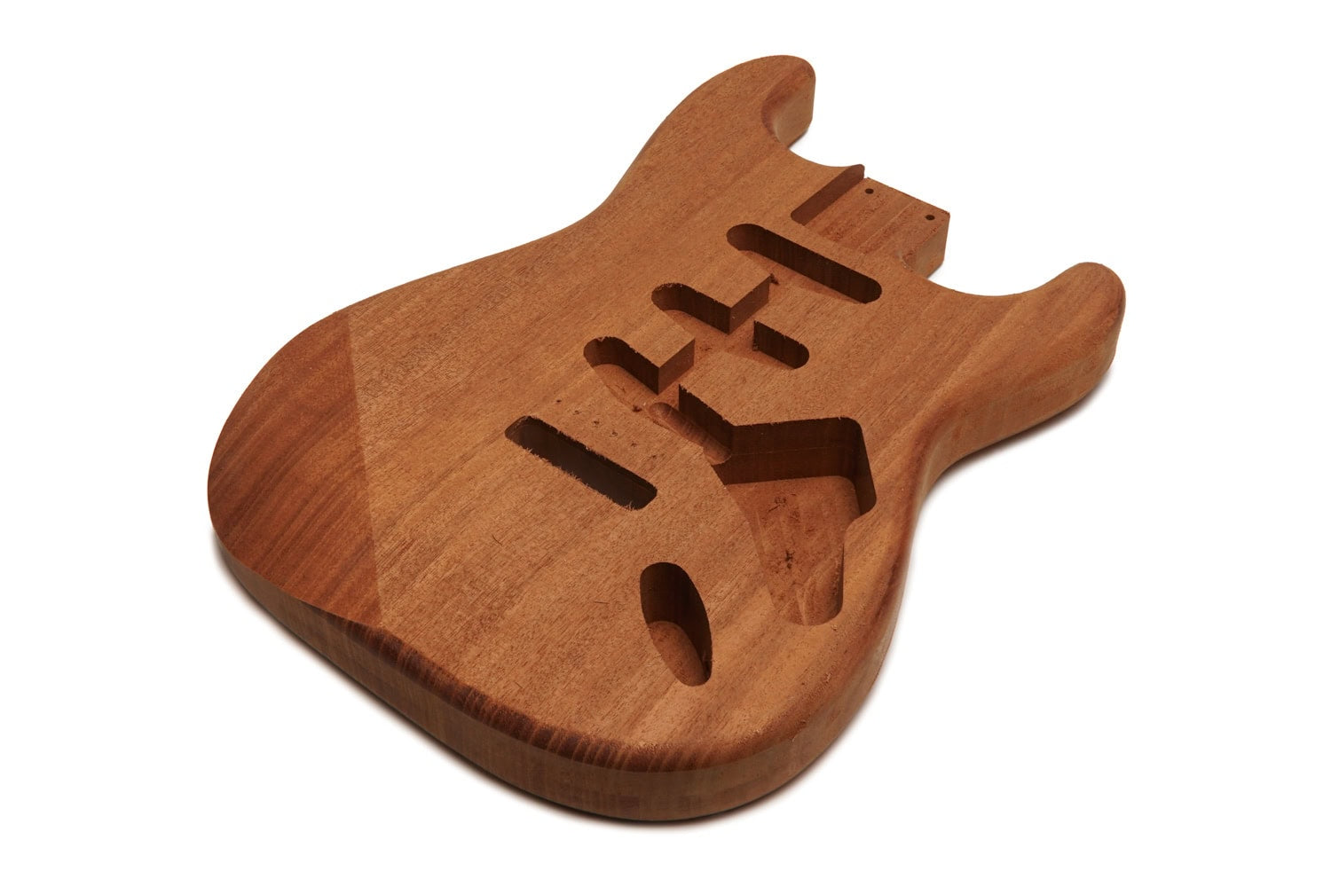 Unfinished brown wooden guitar body with multiple pickup and control cavities on a white background.