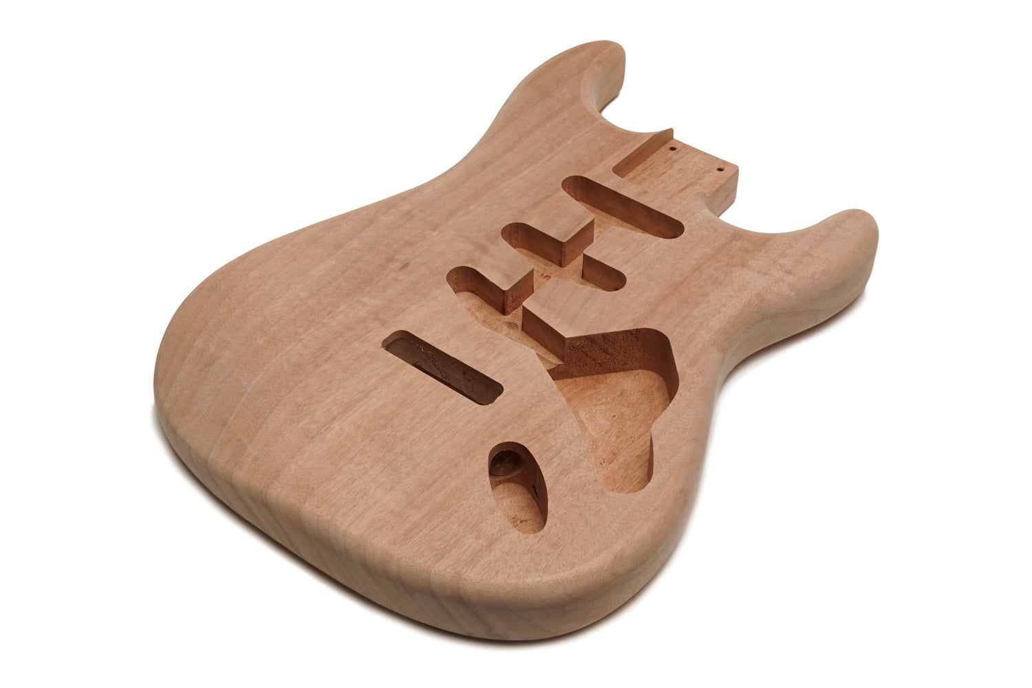 Unfinished light brown wooden guitar body with multiple routed cavities for pickups and electronics.