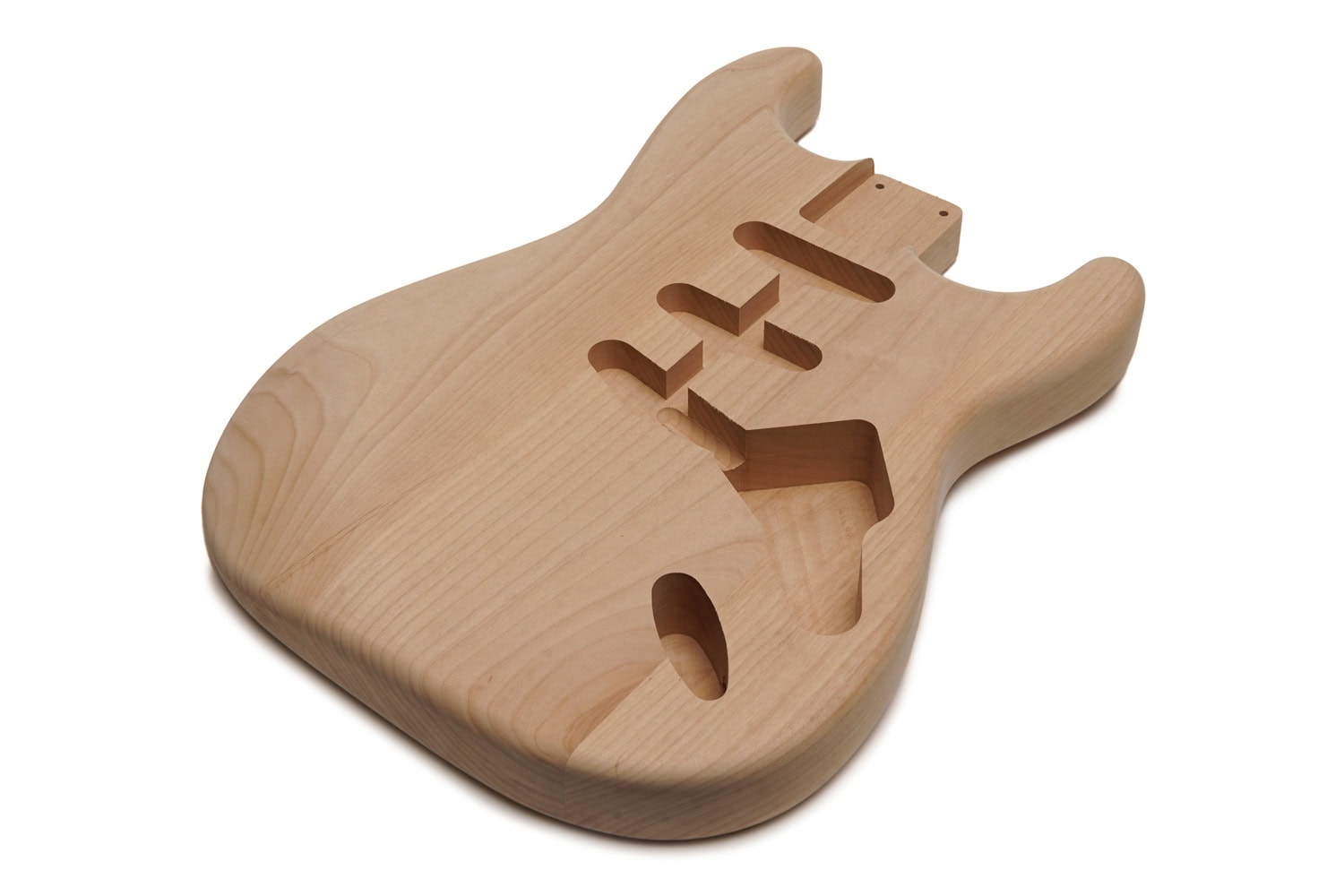 Unfinished natural wood electric guitar body with three pickup cavities and control cavity.