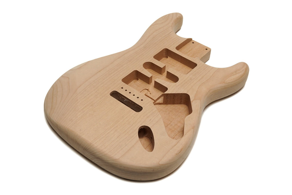 Unfinished natural wood guitar body with routed cavities for pickups and electronics.