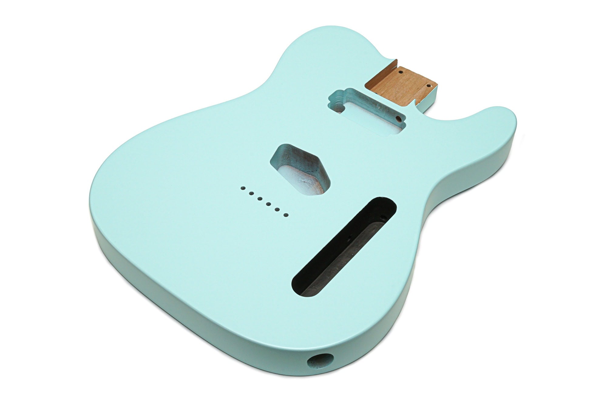 Pastel blue guitar body with routing cavities for pickups and controls on a white background.