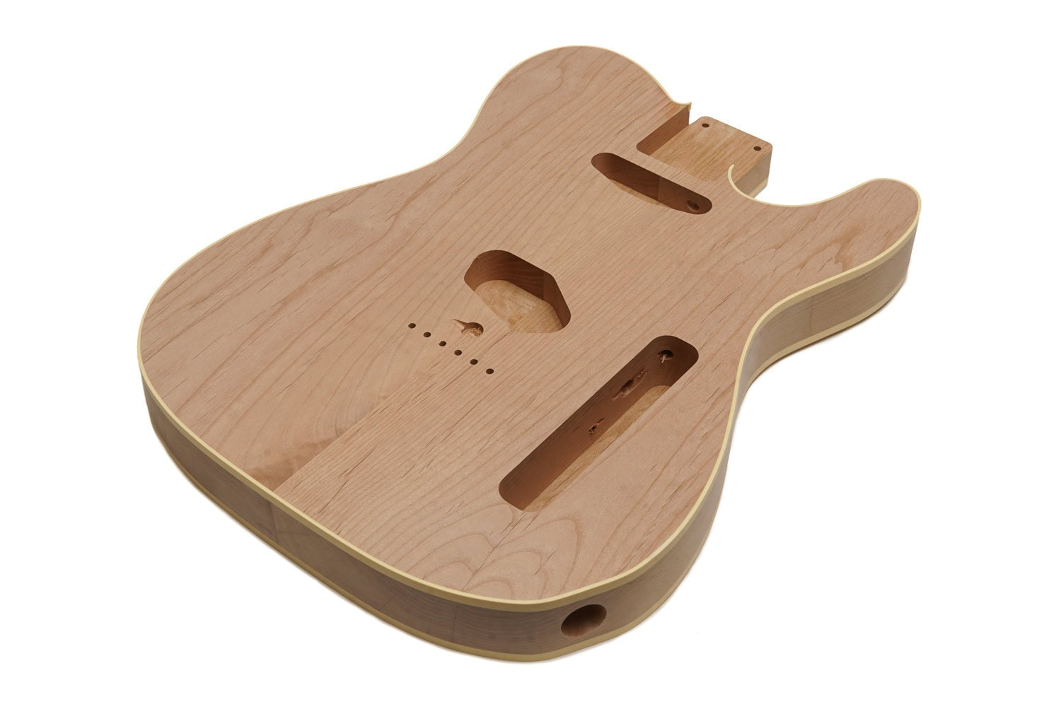 Unfinished wooden electric guitar body with cream binding and routed cavities on white background.