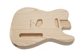 Unfinished natural wood guitar body with multiple routed cavities for pickups and controls.