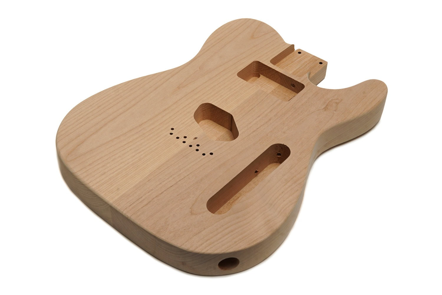 Natural unfinished wood guitar body with routed cavities for pickups and controls.