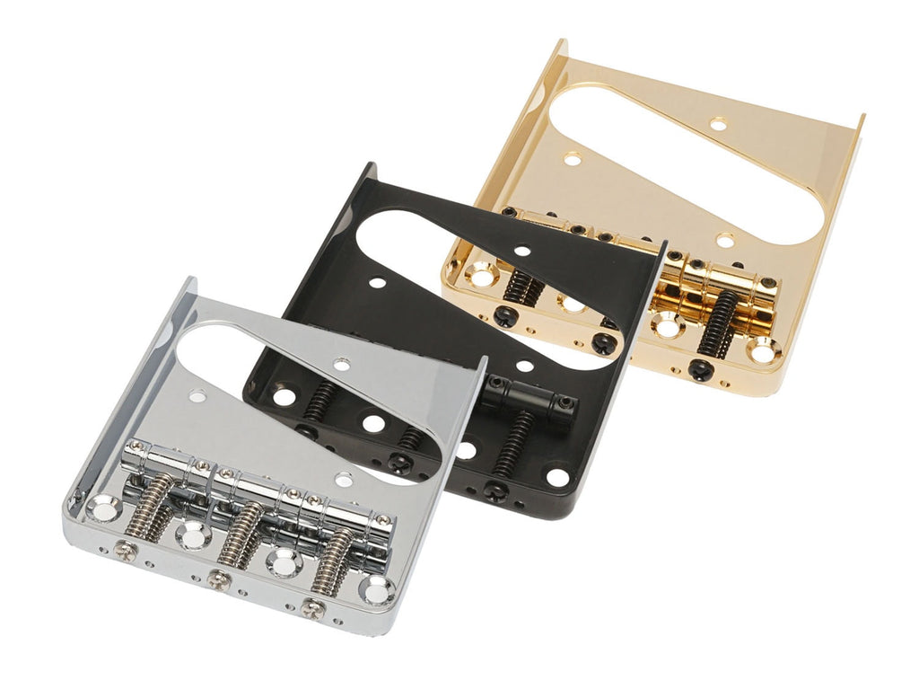 Three metal guitar bridge parts in silver, black, and gold finish with string slots and screws.