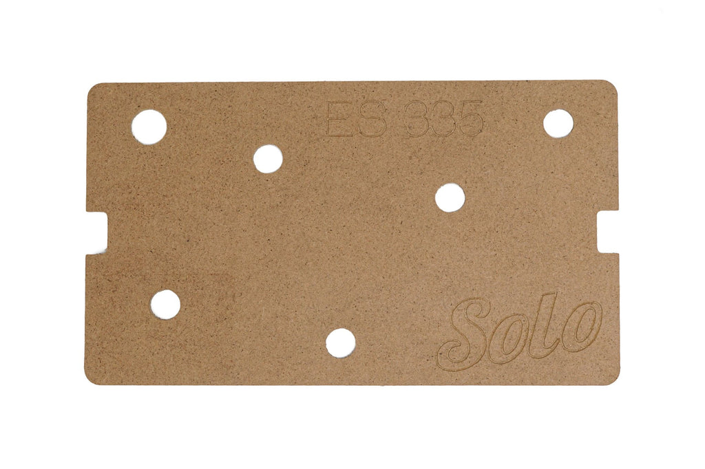 A rectangular brown wooden template with multiple drilled holes and engraved text ES 335 and Solo.