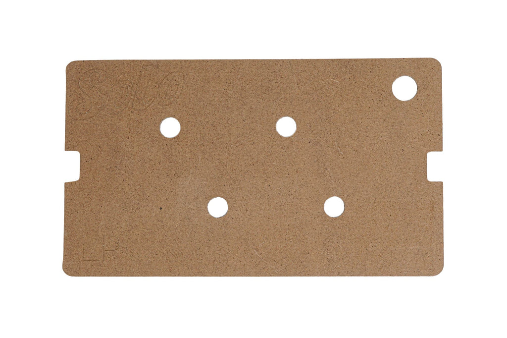 Rectangular wooden template with six circular holes and notched edges, engraved with Solo and LP.
