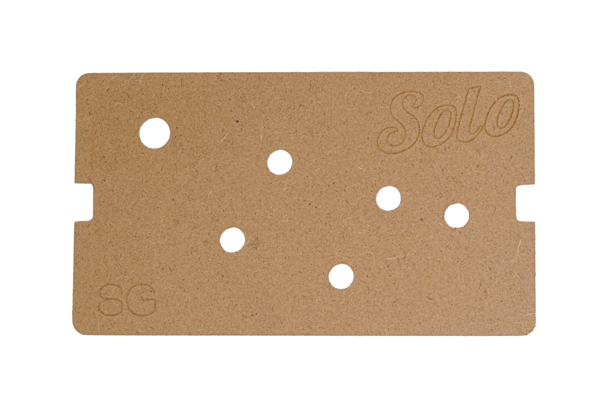 Flat brown wood template board with multiple holes and engraved text 'Solo' and 'SG'