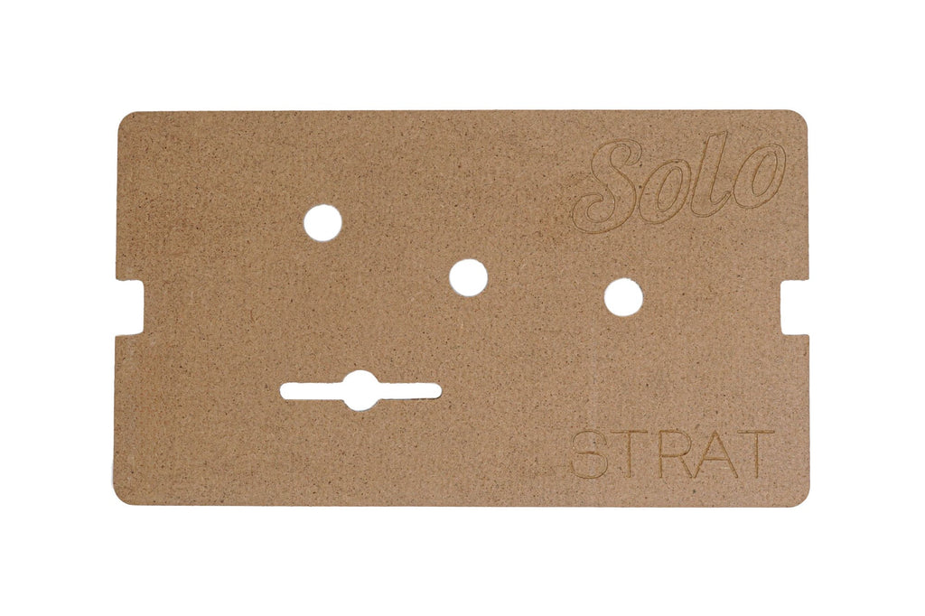 Brown rectangular wood template with multiple cutouts and the words Solo and STRAT engraved on it.