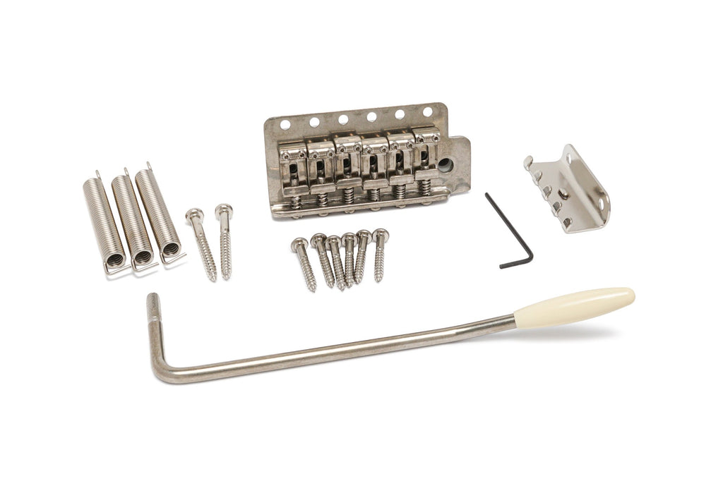Silver metal tremolo bridge setup with springs, screws, hex key, tremolo claw, and arm with off-white tip on white background.
