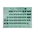 Top view of a mint green audio device with multiple knobs, switches, and 1/4 inch jacks arranged on the front panel.